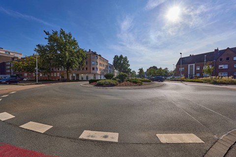 Roundabout at the intersection of Bismarckstraße, Augustastraße and Moltkestraße backlit by the sun
