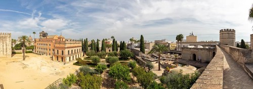 Panoramic view of a cityscape with historic buildings, gardens and palm trees, Jerez
