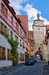 Historic half-timbered house, Hotel Tilman Riemenschneider, with blooming flower boxes in front of
