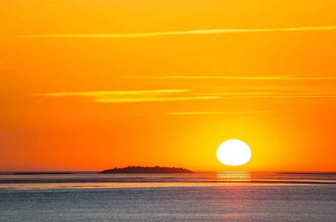 Picturesque, golden, magnificently beautiful sunset over the sea, Langlütjen II island far away,