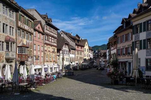 Imposing, historic half-timbered buildings with detailed facade paintings on the market square with