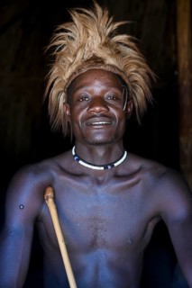 Young Himba man in his hut, Ohandungu, Kunene region, Kaokoveld, Namibia, Africa