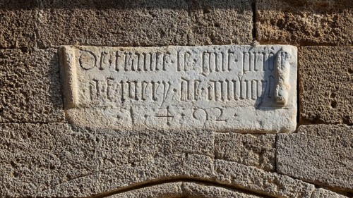 Stone slab with an engraved inscription on an old, historic wall, Knights' Street, Rhodes Old Town,