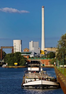 Barge on the Rhine-Herne Canal at the Wanne-Eickel lock with the STEAG power plant in Baukau,