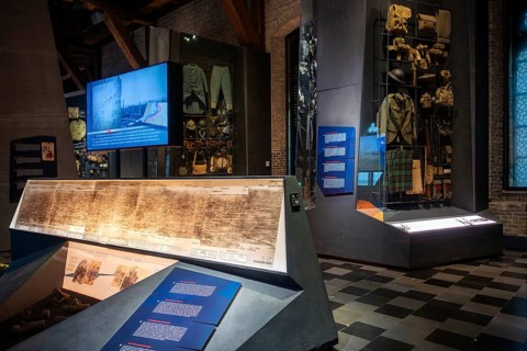 WWI soldier's equipment on display and battlefield map in the In Flanders Fields Museum about World