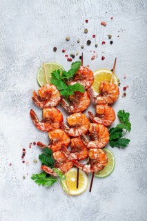 Fried shrimp, without a head, on skewers, shrimp kebabs, with spices, grilled, homemade, without