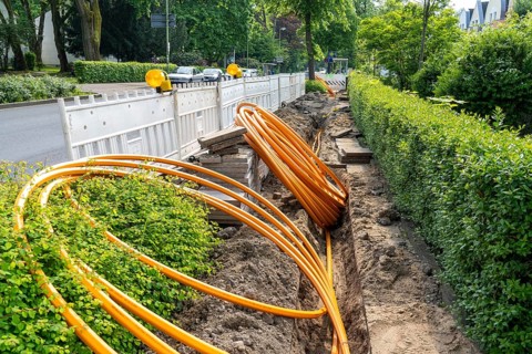 Laying of fibre optic cables, empty conduits are laid under a pavement, in which the actual fibre