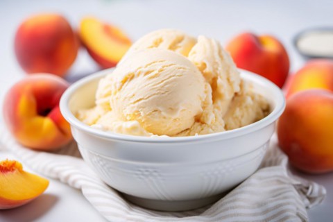 Bowl with peach ice cream surrounded by fruits. KI generiert, generiert, AI generated