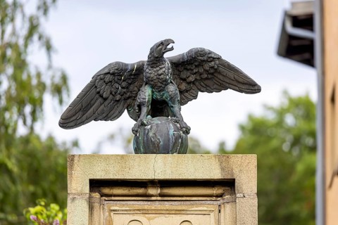 Eagle with globe, sculpture, artwork at a courtyard entrance in Stuttgart, Baden-Württemberg,