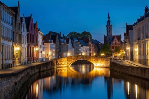 European medieval night city view background, Bruges (Brugge) canal in the evening, Belgium, Europe