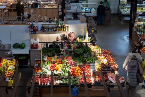 Fruit and vegetable stall with Cucumbers, tomatoes, melons, Leeks, Malus and spices, Riga, Latvia,