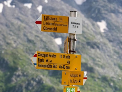 Signpost indicating highest point on Furka mountain pass, hiking pass directions, Switzerland,