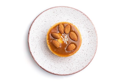Sweet tartlets with almonds and caramel cream isolated on white background. top view, flat lay,