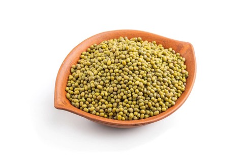Clay bowl with raw green mung bean isolated on white background. Side view, close up