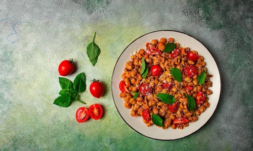 Tuscan pasta with smoked paprika and basil, parmesan cheese, Italian traditional cuisine