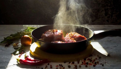 Delicious meat stakes cooked on a pan. Wooden cutting board with spices and oil, AI generated