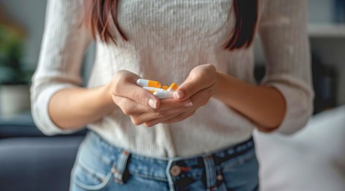 Woman with painkillers suffering for menstrual or stomach pain or other sickness. Overmedication,