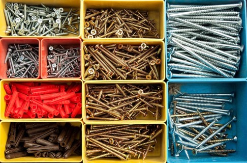 Colourful carpentry box of metal screws viewed rom above