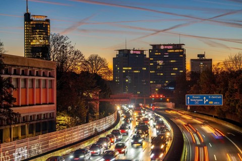 Evening traffic, partly with traffic jams, slow-moving traffic on the A40 motorway, skyline of
