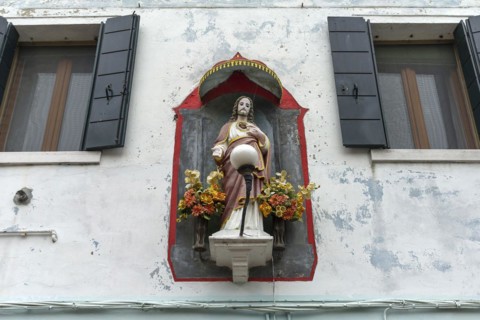 Christ figure with canopy on a house, Burano, Venice, Veneto, Italy, Europe
