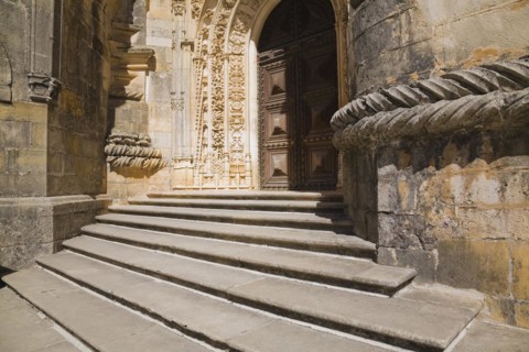 Steps and arched entrance door decorated with architectural details at the Convent of Christ in