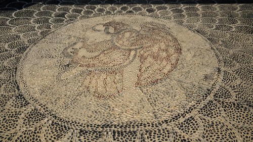 Pebble mosaic with an intricate facial motif, Mandraki, Nisyros, Dodecanese, Greek Islands, Greece,