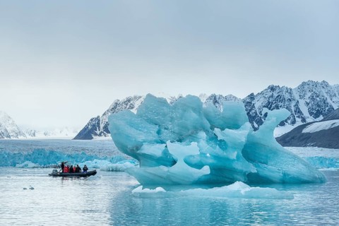 Dinghy with tourists, iceberg and glacier edge of Monacobreen, Liefdefjord, Woodfjord area,