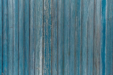 Garage door boards stained blue with worn paint. Brittany France