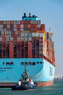 Container ship of the shipping company Maersk Line, Maastricht Maersk, leaving the harbour, towed