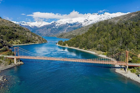 Aerial view of famous orange suspension bridge Puente General Carrera, bridge spans the connection