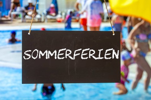 Symbolic image summer holidays: Sign with the inscription SUMMER HOLIDAYS in front of summer