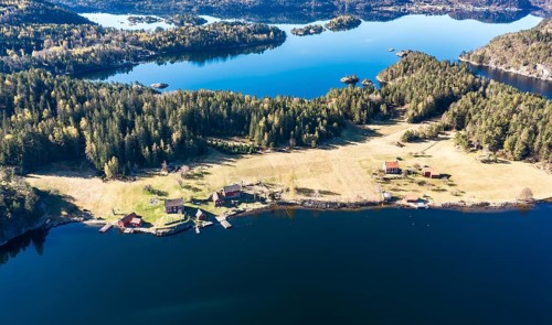 Farm with red houses on an island near Risor, aerial view, norwegean southern coast, Norway, Europe