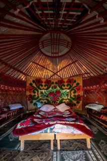 Traditional Kyrgyz yurt for overnight accommodation for tourists, with four beds and carpets, Naryn