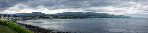 Coastal panorama with mountains in the background and cloudy sky, Ballycastle