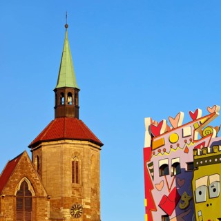 Magnikirche next to the Happy Rizzi House by the artist James Rizzi, architectural contrast,