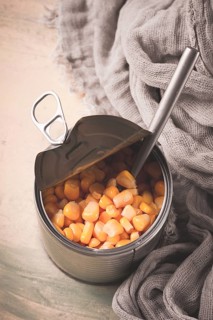 Open tin can, with corn, top view, selective focus, no people, close-up