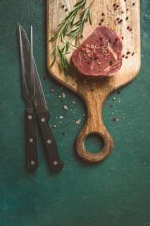 Fresh, raw rib eye steak, on a chopping board, top view, no people