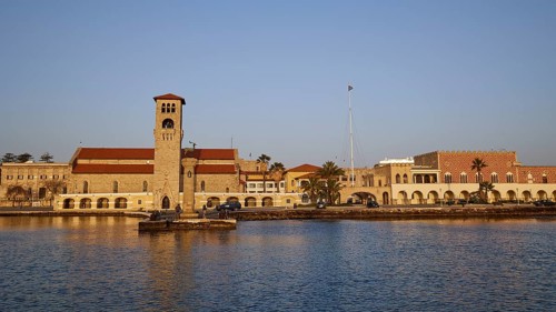 Church at the harbour, surrounded by calm sea and clear blue sky at morning light, Church of the