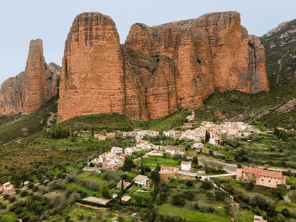 View of a small village surrounded by huge rocks and green landscape that gives a quiet and rural