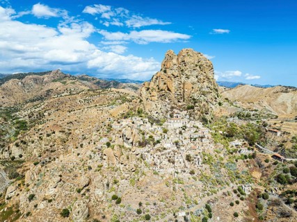 Mountains and Olive groves around Ghost Town from a drone, Pentedattilo Village, Calabria, Italy,