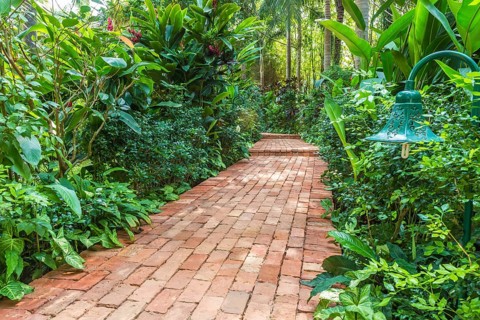 Red brick path in a tropical garden