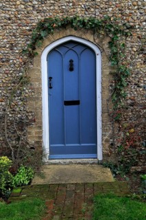 Blue door in flint home, Suffolk, England, UK