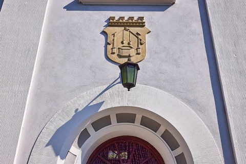 Facade of a house in the classicist style with the coat of arms of the salt boiling trade and
