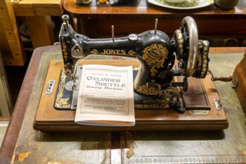 Jones Sewing Machine Company Family Cylinder Shuttle model with instruction manual on display in