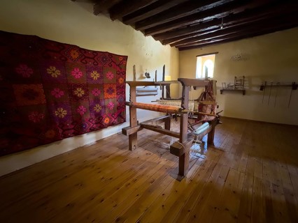 Room with traditional loom left on wall traditionally woven carpet in Xopatera Tower Tower of