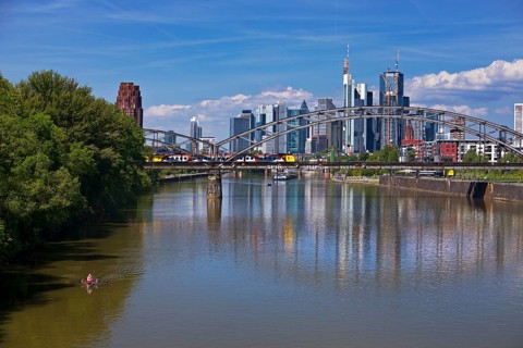 The river Main with regional railway on the Deutschherrnbrücke and the skyline of Frankfurt am