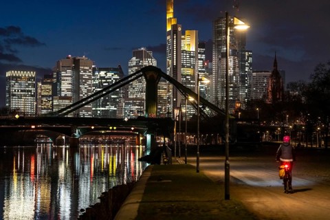 Skyline of the city centre of Frankfurt am Main, cyclist with light on the cycle path, pavement,
