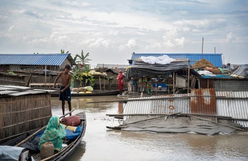 Morigaon, India. 4 July 2024. A settlement is partially submerged in flood in Morigaon district in