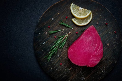Fresh red tuna fillet, for steak, raw, top view, on a cutting board, no people