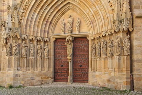 Sculptures on the Virgin Mary portal with tympanum and Archangel Michael, Gothic church portal,